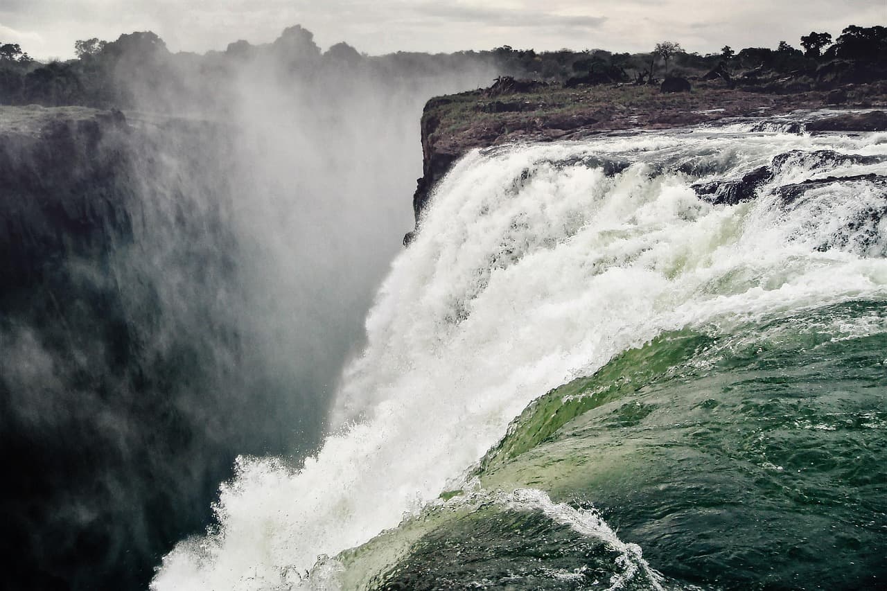 Water pouring over the edge of Victoria Falls in clouds of spray, Zambia