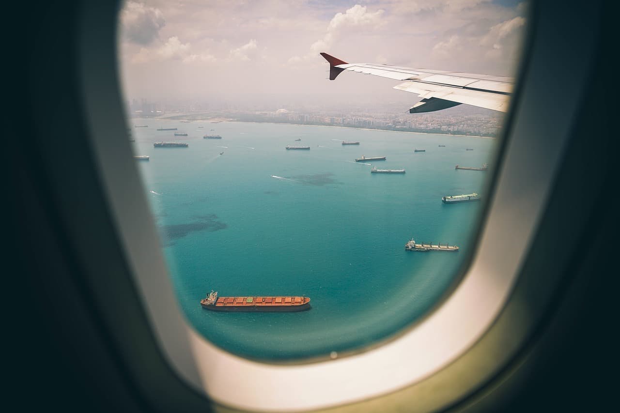 An aeroplane wing seen through a cabin window