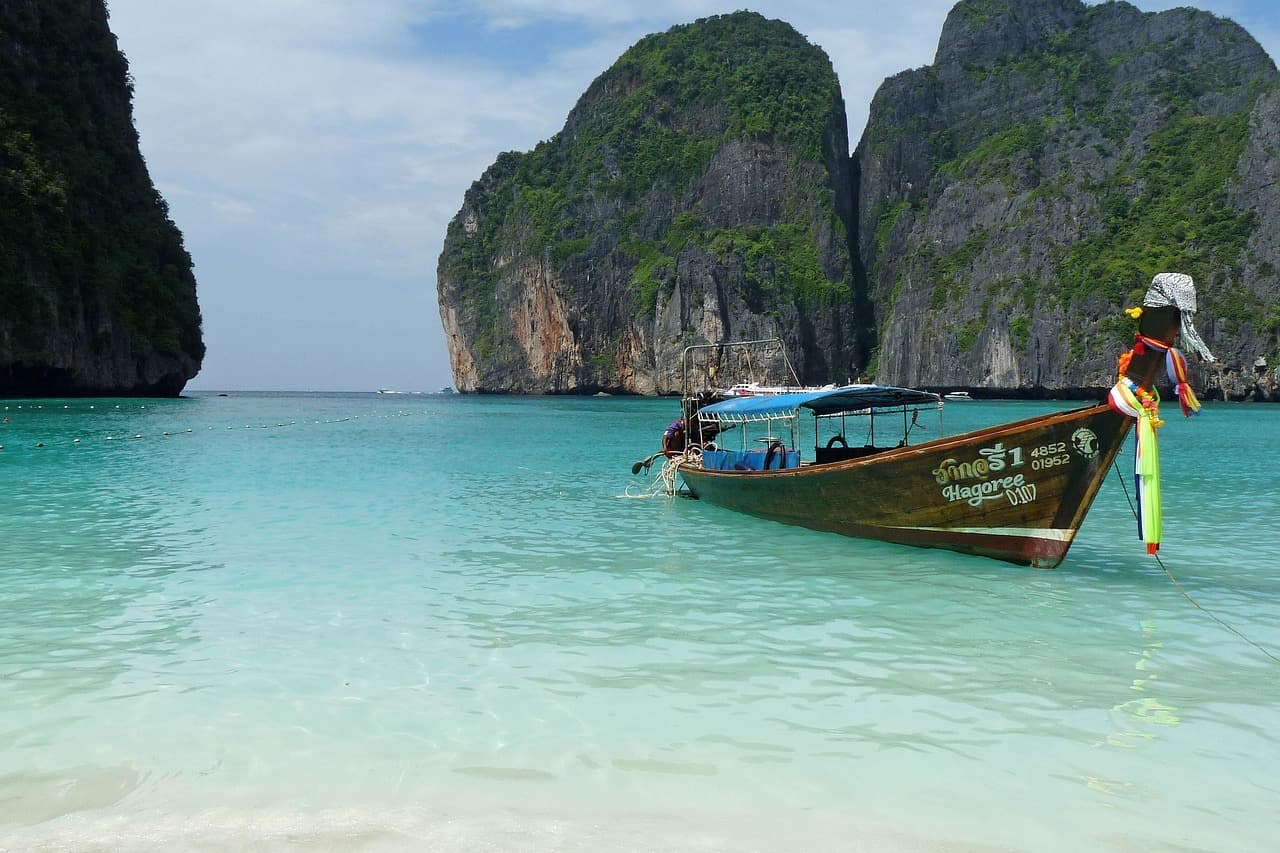A longtail boat moored in clear water off Koh Phi Phi, Thailand