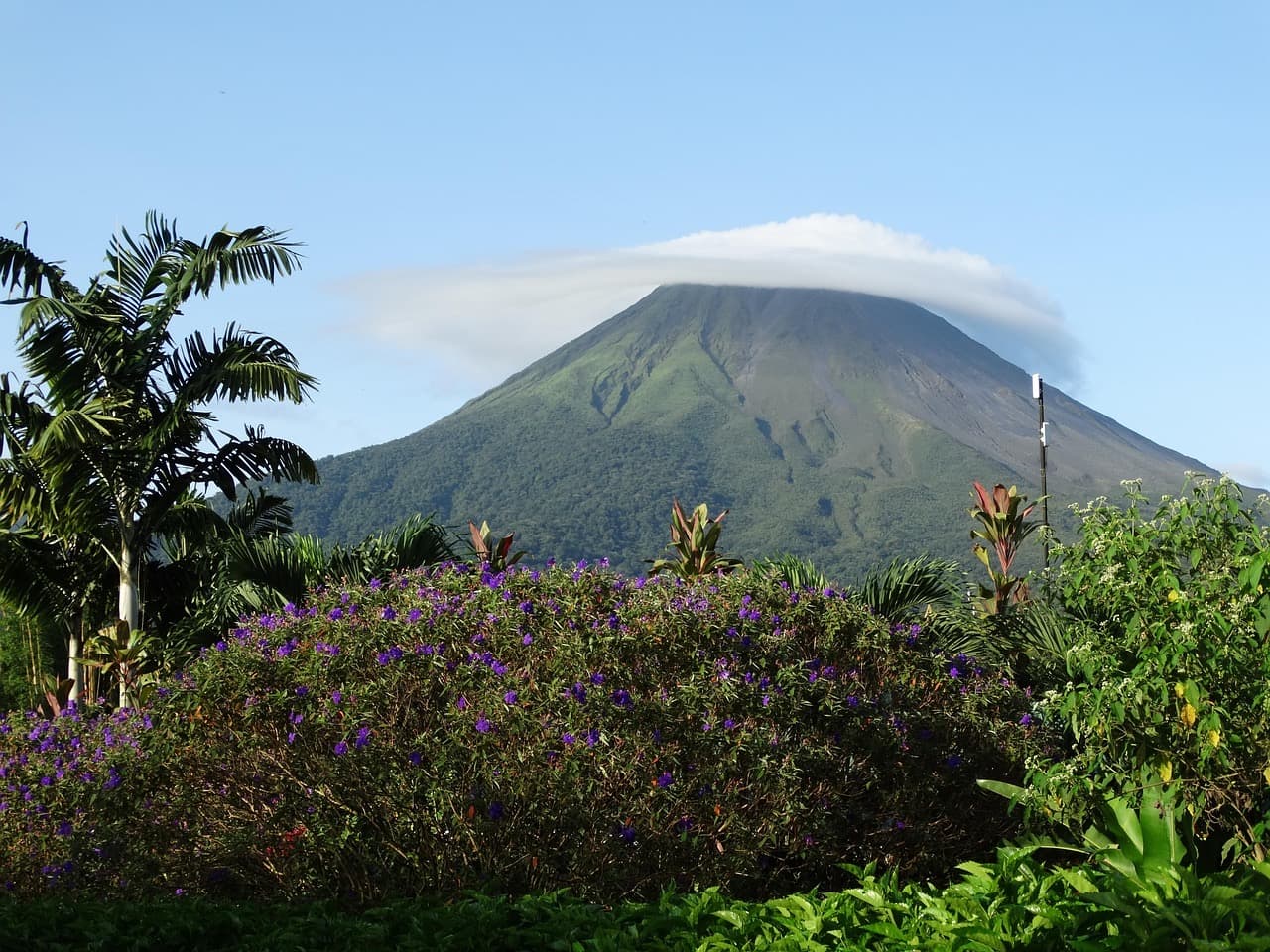 A volcano rising above green forest in Costa Rica